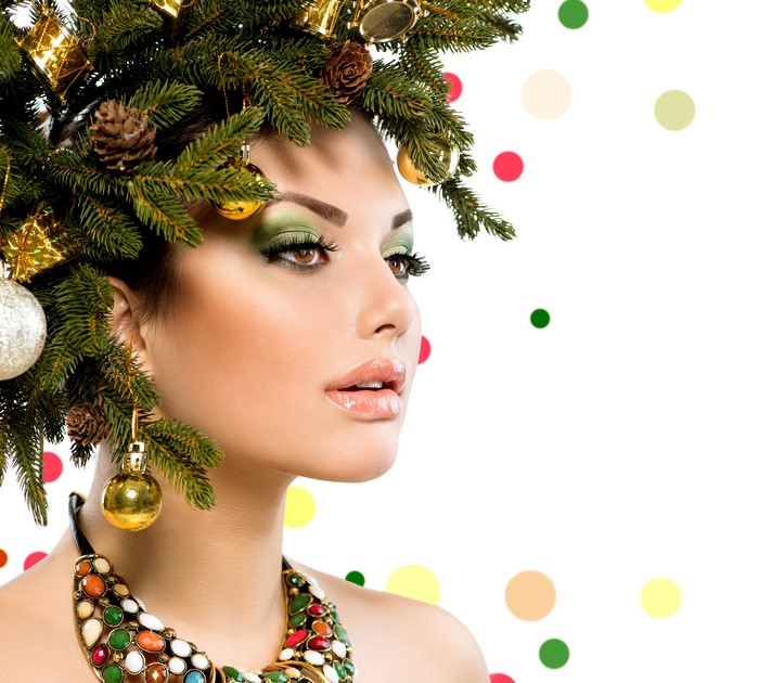 Woman with Christmas tree branches and ornaments in hair