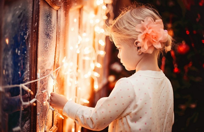 Girl decorating Christmas lights