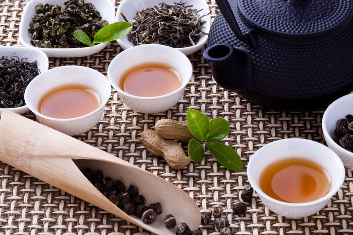 Tea ceremony with assorted teas and nuts
