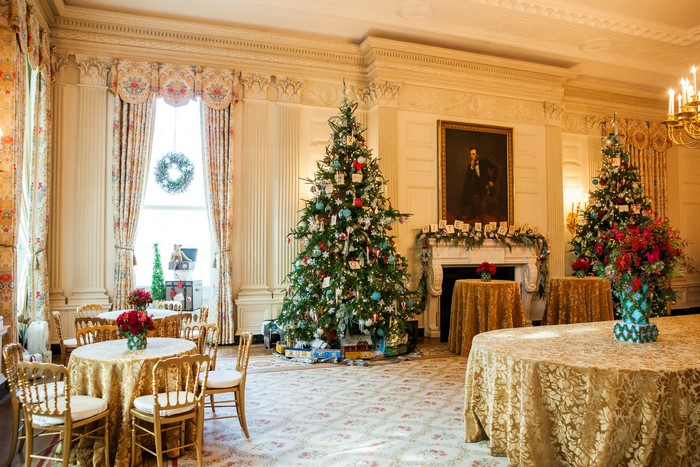 Christmas trees and decorated tables in a room