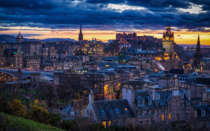 Edinburgh cityscape at dusk with castle and clock tower