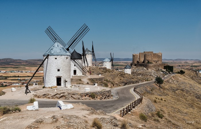 Windmills and castle on a hill