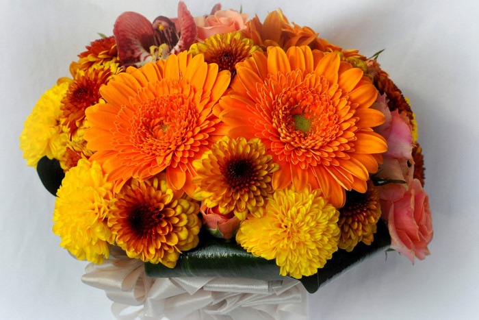 Orange and yellow flower bouquet with roses and orchids