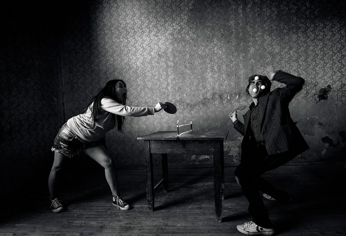 Man and woman playing table tennis