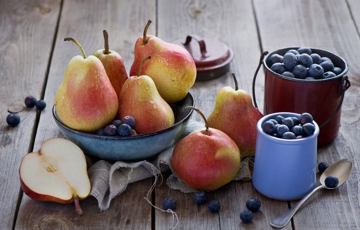 Pears and blueberries on a wooden table