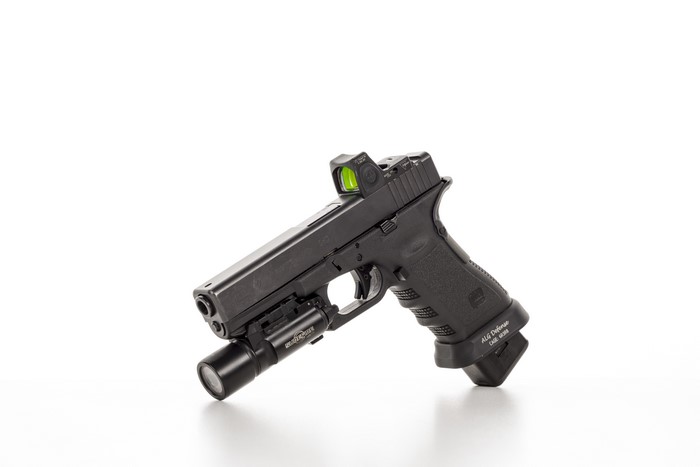 Glock 17 pistol with red dot sight and flashlight