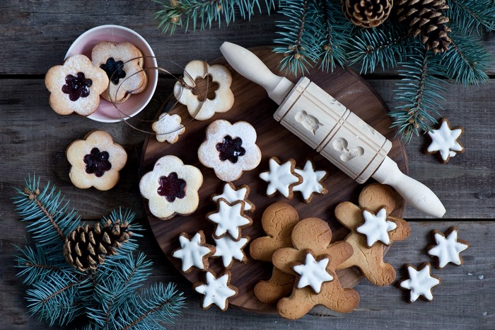 Christmas cookies and pine branches on wooden table