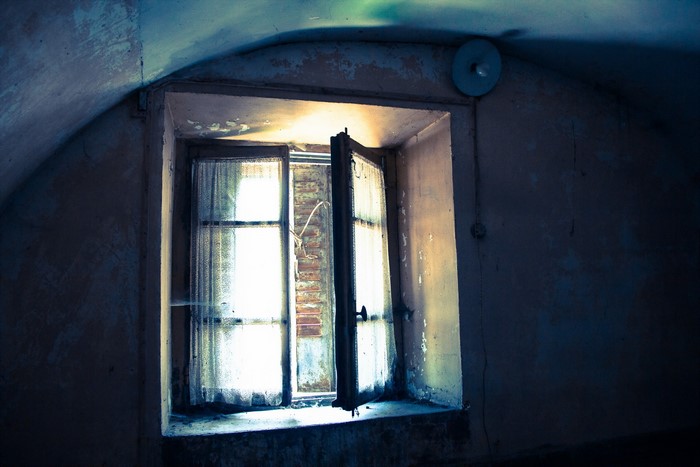 Abandoned room with an open window