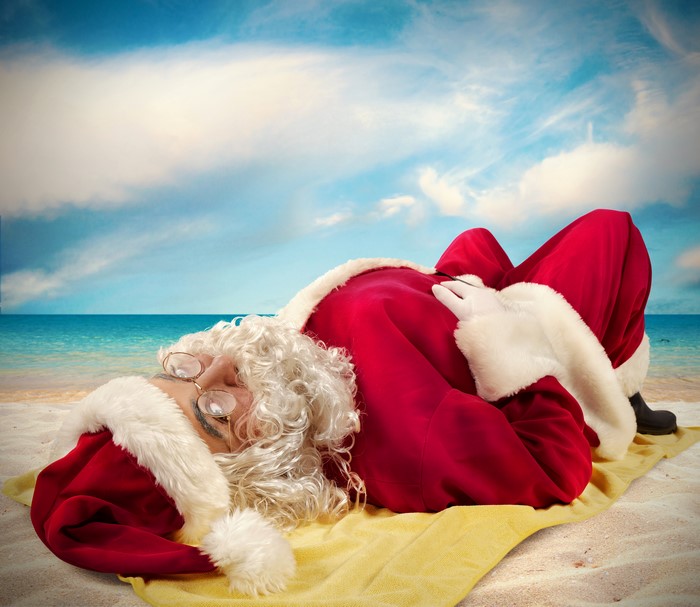 Santa Claus relaxing on a beach