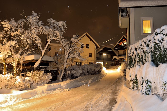 Winter night in Bled, Slovenia with snow-covered houses and street