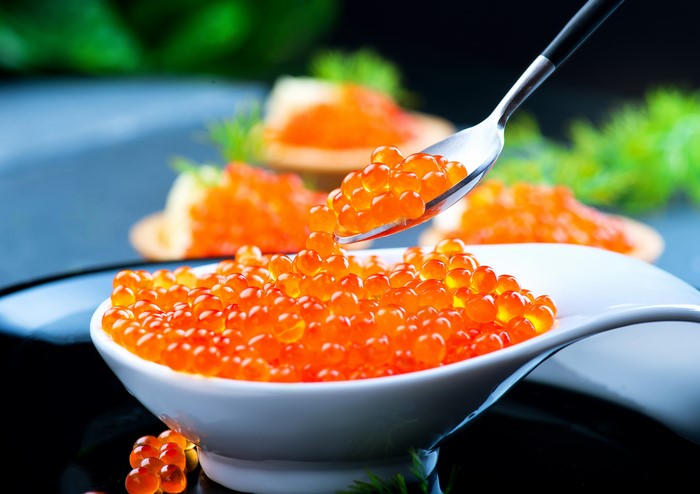 Red Caviar on a Spoon and in a Bowl