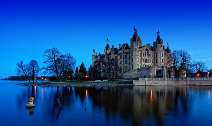Schwerin Castle on a lake at dusk, Germany