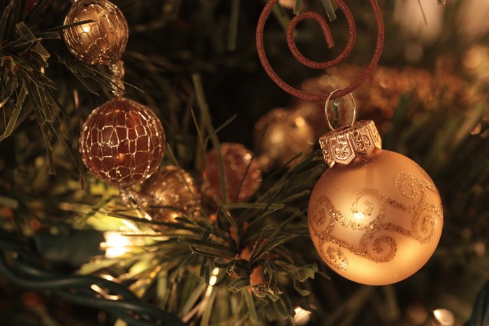 Gold Christmas ornaments on a tree