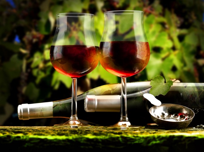 Two glasses of red wine and a bottle