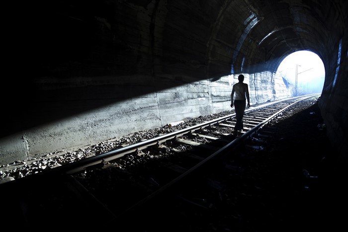 4K Silhouette of Person Walking in Tunnel