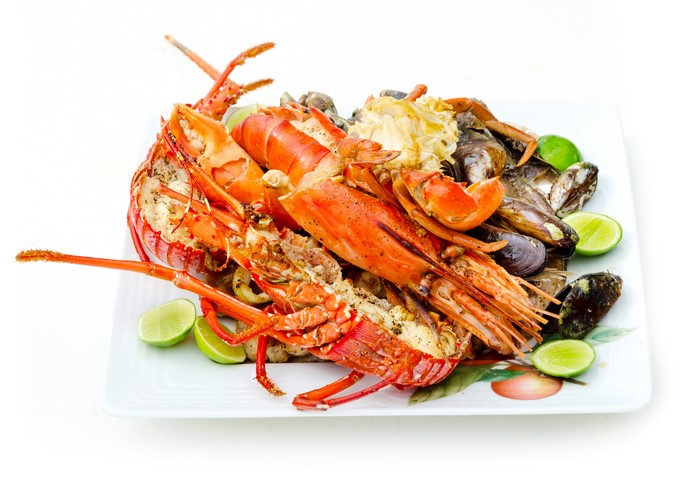 Seafood platter with lobster, mussels, clams, and lime