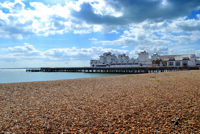 Pier and beach with cloudy sky