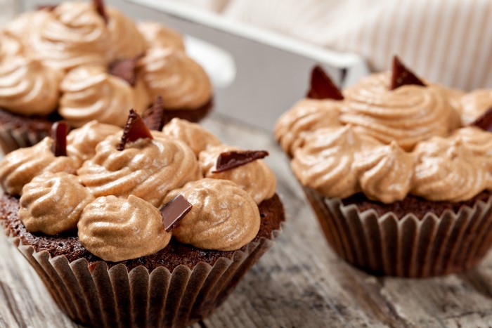 Chocolate cupcakes with caramel frosting and chocolate shavings