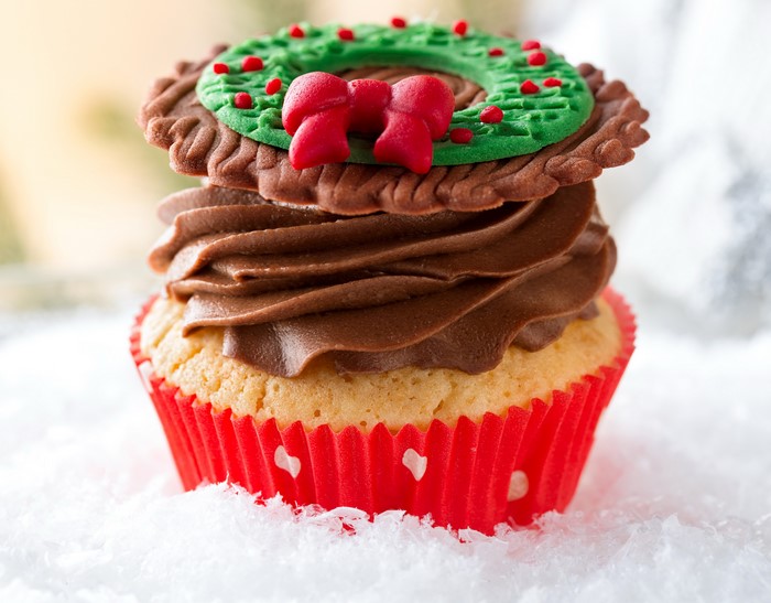 Christmas cupcake with chocolate frosting and wreath decoration