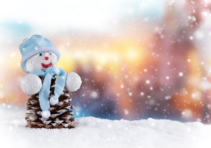 Snowman made of pine cone with blue hat and scarf