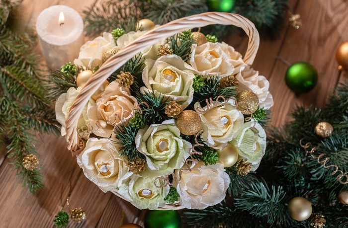 Christmas candy bouquet in a wicker basket with fir branches