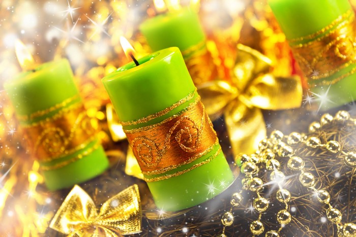Green candles with gold ribbon and decorations