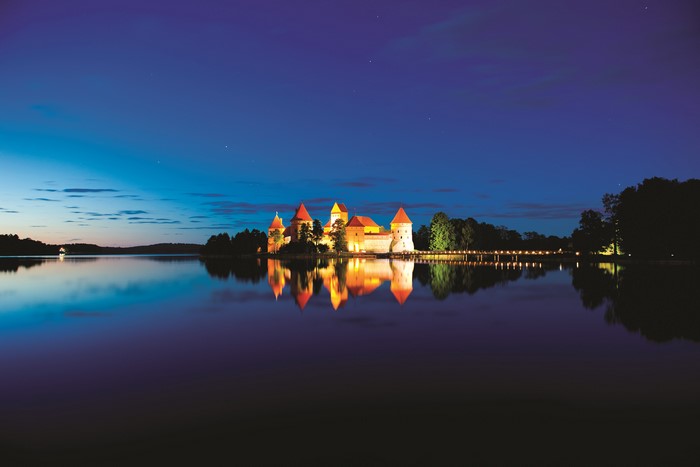 Trakai Island Castle at night reflected in a lake