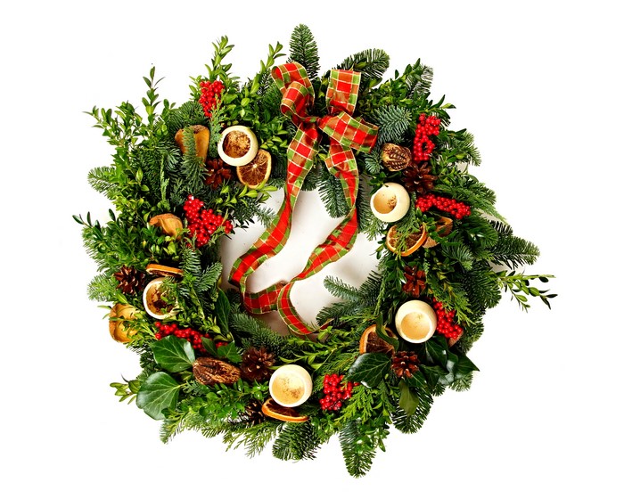 Christmas wreath with bowknot, candles, and pinecones