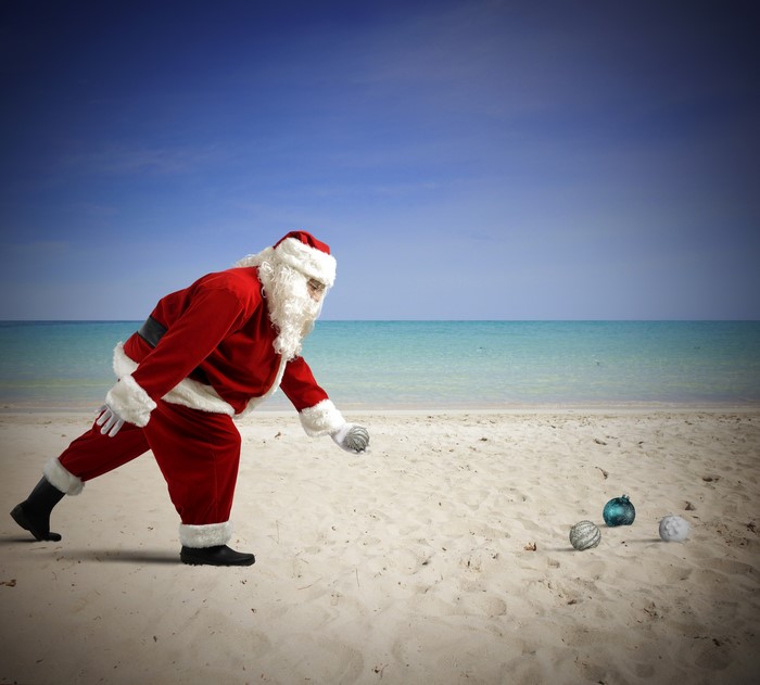 Santa Claus on a beach with Christmas ornaments