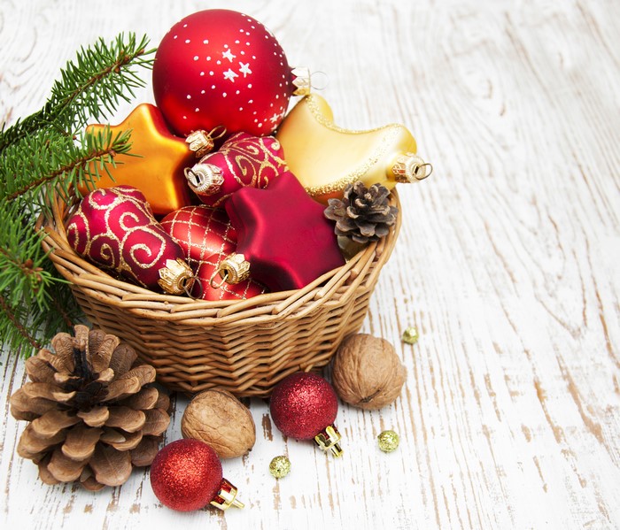Christmas Ornaments in a Wicker Basket with Pine Cones and Nuts
