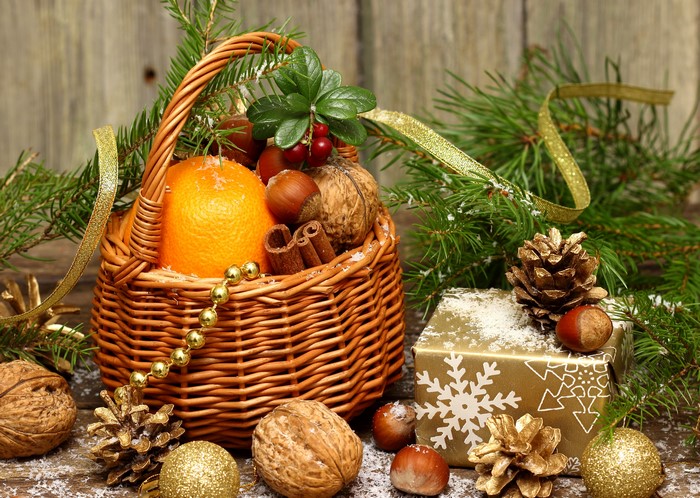 Christmas basket with nuts, mandarin, and pine cones