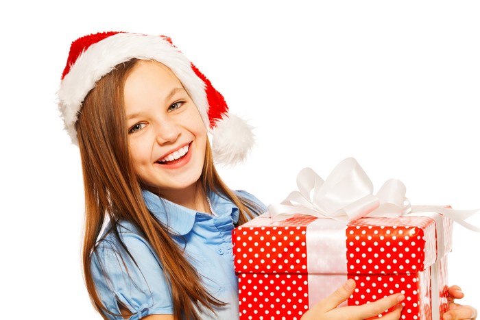 Smiling Girl in Santa Hat Holding Christmas Gift