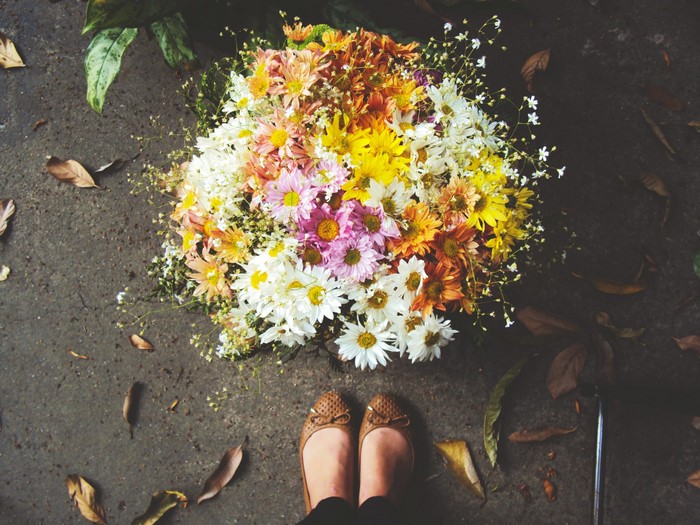 Bouquet of flowers with legs and fallen leaves