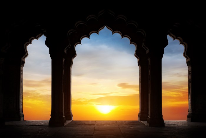 Silhouette of arches against a sunset sky