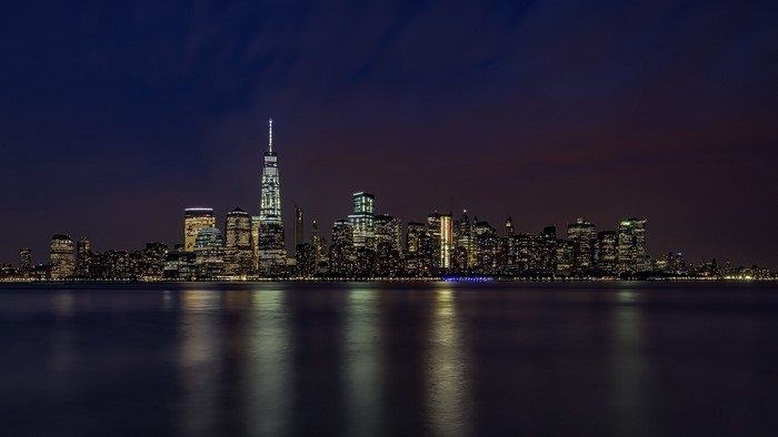 New York City skyline at night with reflections