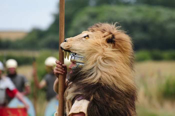 Man in Lion Headdress Holding Spear