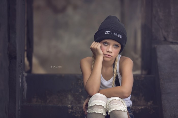 Girl in Winter Hat Sitting on Steps