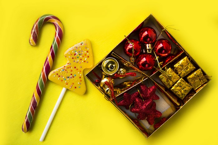 Christmas candy cane and lollipop with ornaments in a box