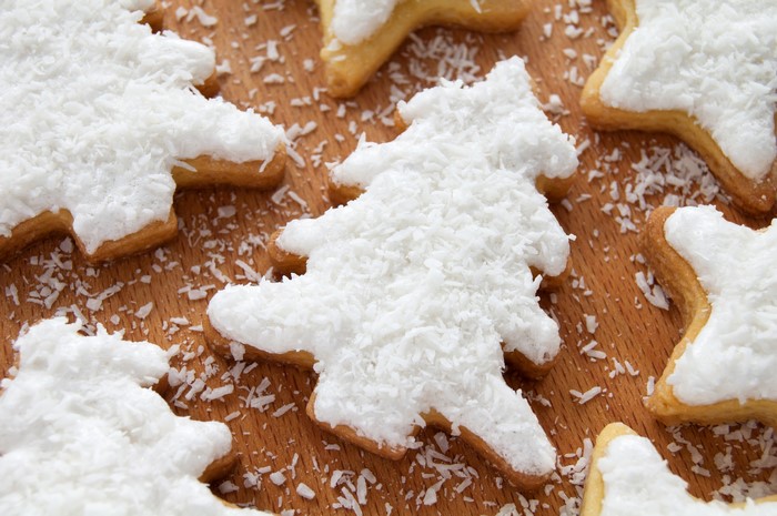 Christmas tree and star cookies with white icing and coconut