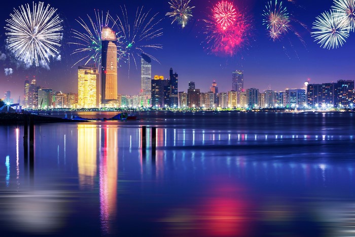 Fireworks over a city skyline at night