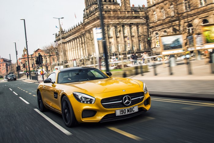 Yellow Mercedes-Benz AMG GT S driving on a city street