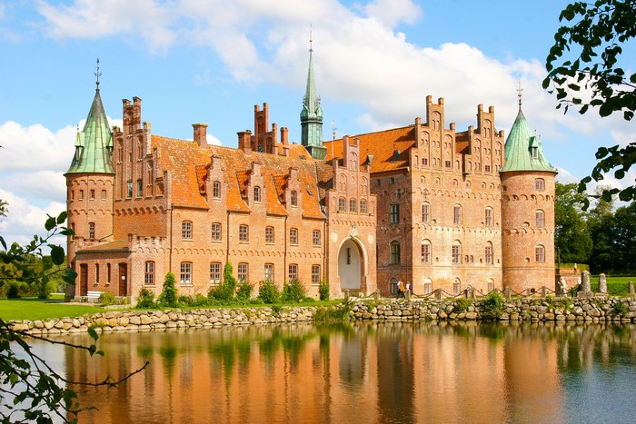 Egeskov Castle in Denmark reflected in a pond