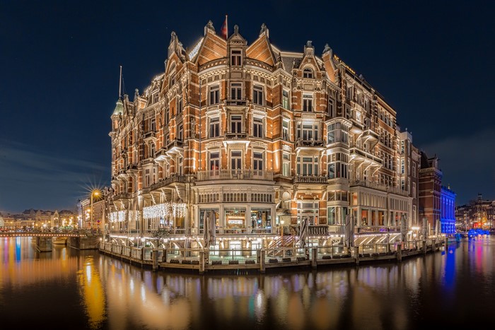 Hotel De L'Europe on a canal in Amsterdam at night