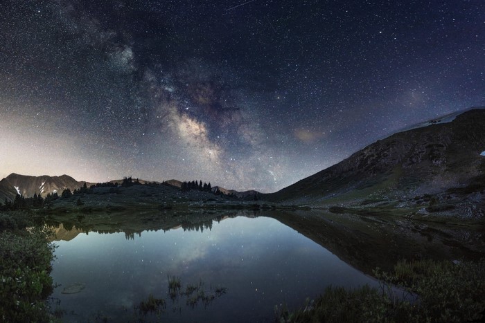 Milky Way over a mountain lake at night