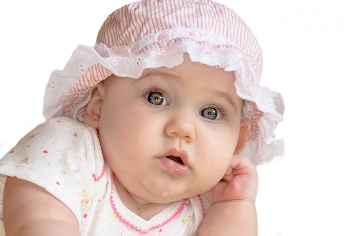 Baby wearing a pink and white striped hat