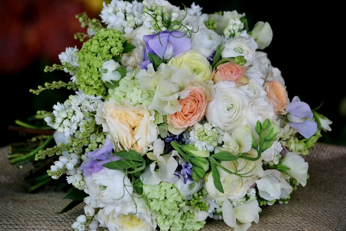 Wedding bouquet with roses, ranunculus, and hydrangeas
