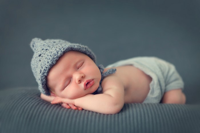 Baby sleeping wearing a winter hat