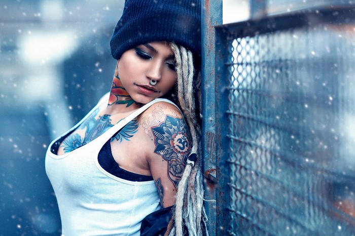 Woman with tattoos and winter hat