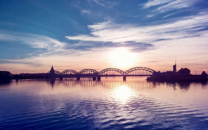 Bridge over river at sunset