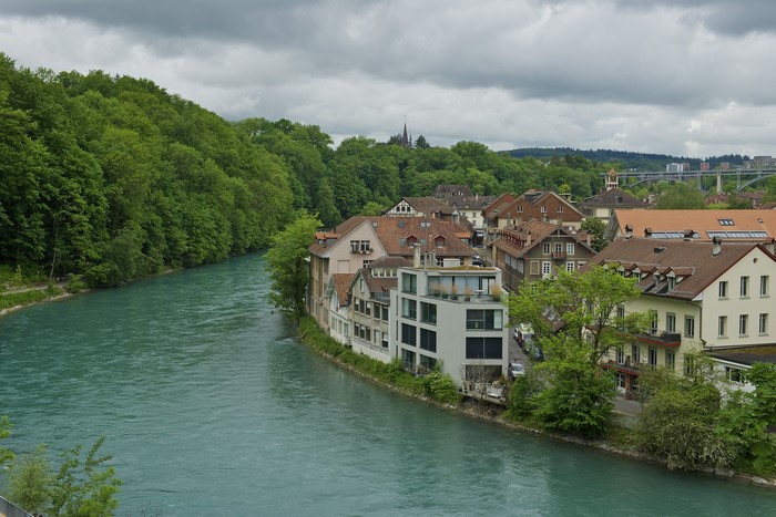 Bern, Switzerland: River and Houses with Green Trees